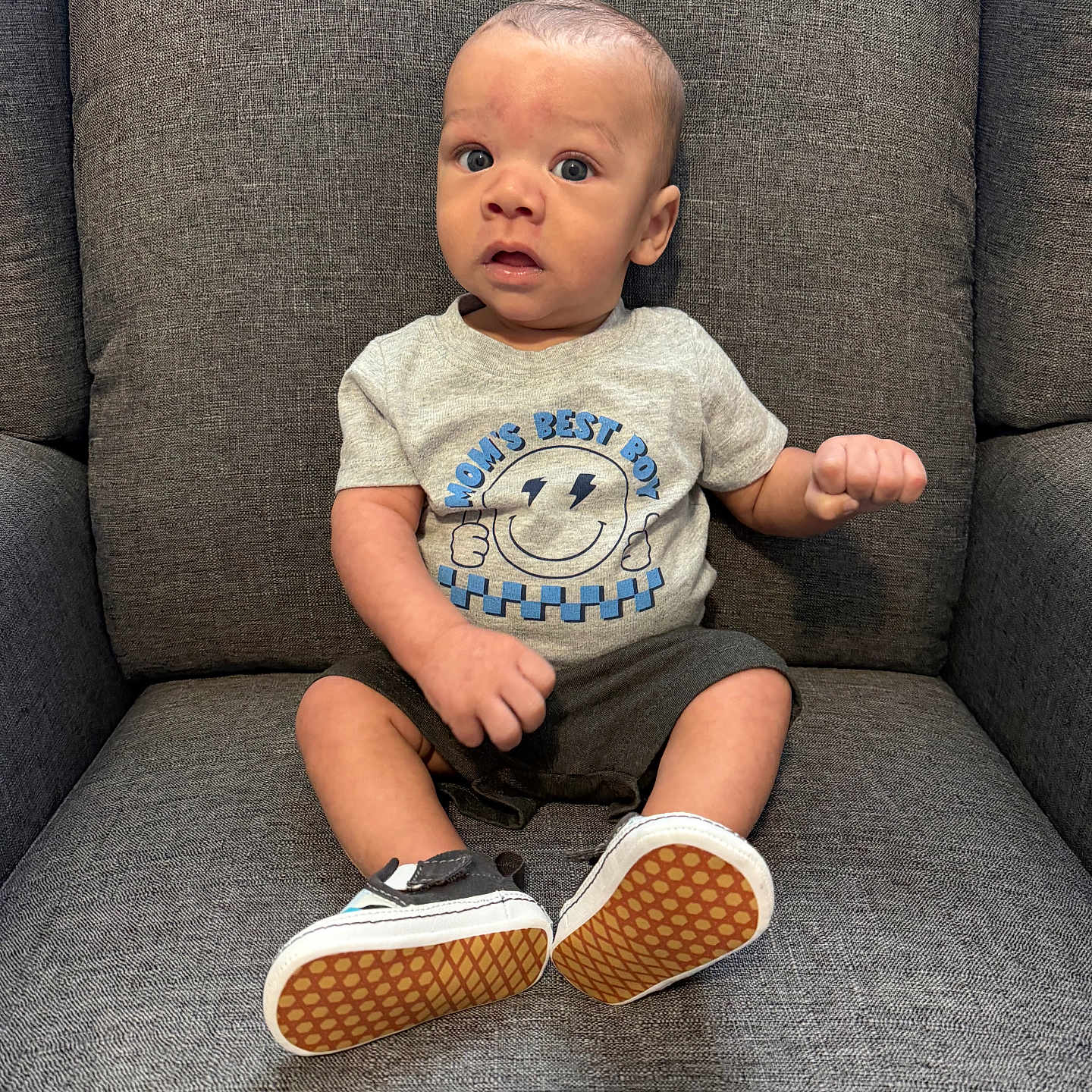 Kayson joined the competition — help win amazing prizes! baby, boy, child, infant, armchair, gray, clothing, shirt, shoes, face, expression, sitting, furniture, indoors, cute, portrait, person, feet, happy, small