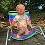 toddler, child, outdoor, chair, playful, tongue_out, smiling, nature, trees, dirt, sunlight, grass, summer, barefoot, shorts, shirt, baby, seat, happy, daytime