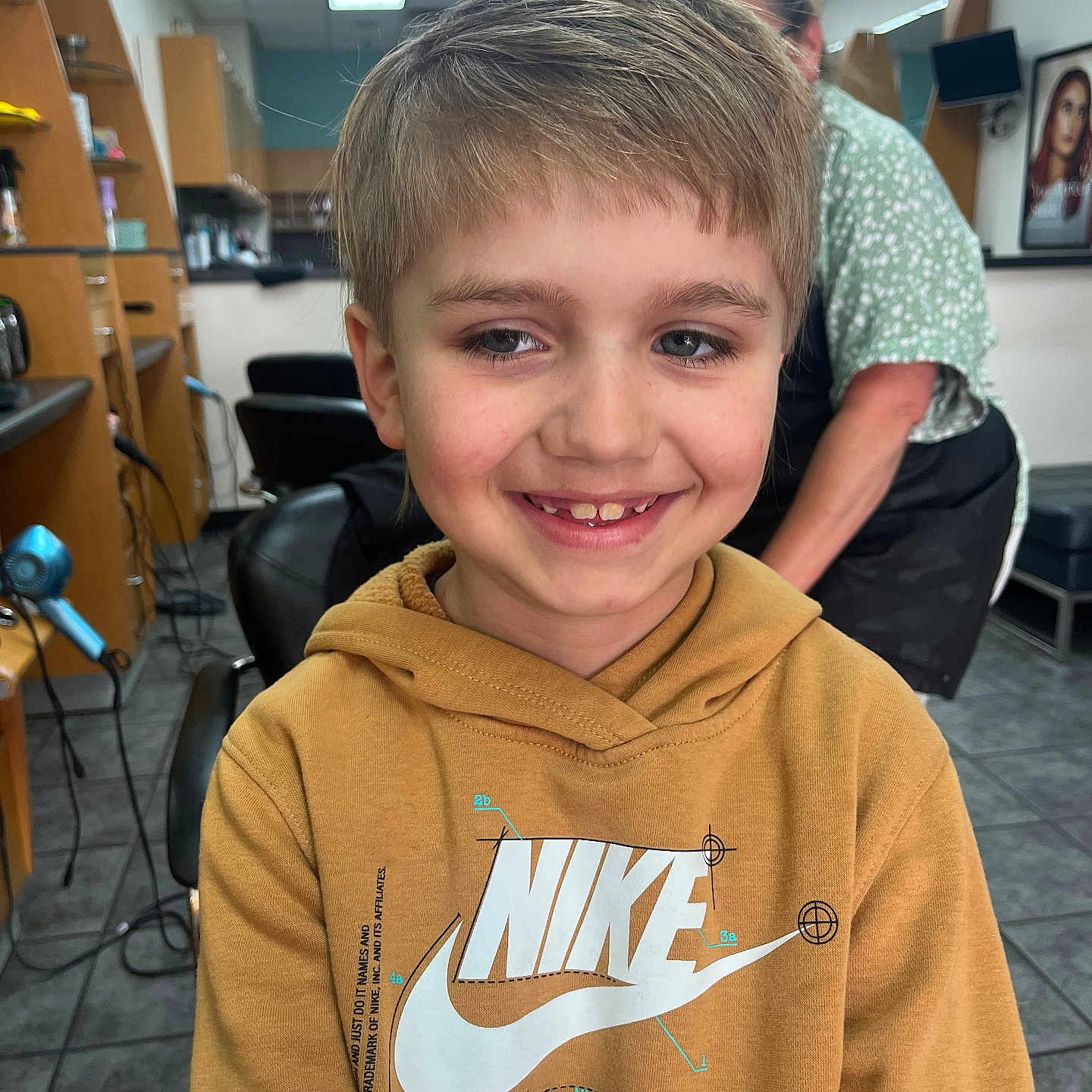 Michael joined the competition — help win amazing prizes! boy, cabinet, casual_clothing, chair, child, floor, haircut, hairdresser, hairdryer, happy, hoodie, indoor, lighting, nike, people, person, portrait, salon, smile, tile_floor