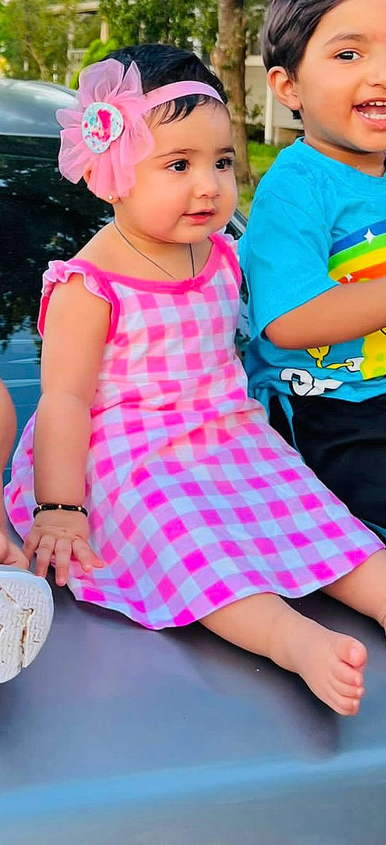 Syeda is registered to the contest to win money with this photo: baby_toddler_clothing, child, day_dress, finger, fun, gesture, happy, headwear, joy, leisure, magenta, pattern, person, pink, recreation, sleeve, summer, t_shirt, tableware, thigh