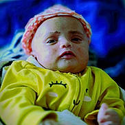 Afiya joined the competition — help win amazing prizes! baby, infant, yellow_clothing, pink_hat, blanket, face, person, young_child, portrait, indoors, cozy, soft_fabric, sleepy, close_up, cute, child, warm_clothing, blurred_background, resting, small_hands