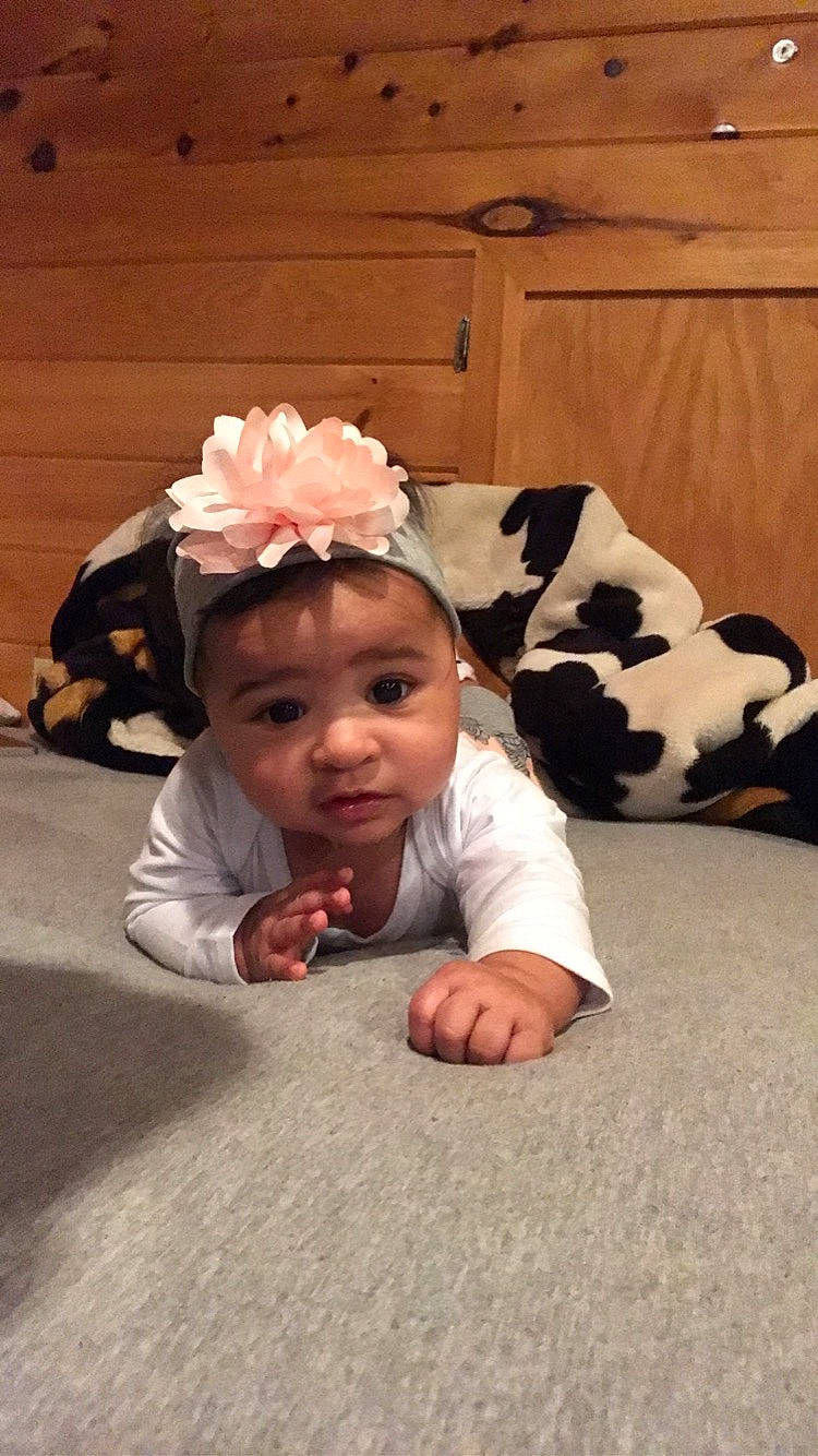 Cleo joined the competition — help win amazing prizes! baby, baby_toddler_clothing, child, eye, fashion_accessory, floor, flooring, flower, fun, hair, happy, head, headband, headgear, headpiece, person, petal, sitting, skin, toddler
