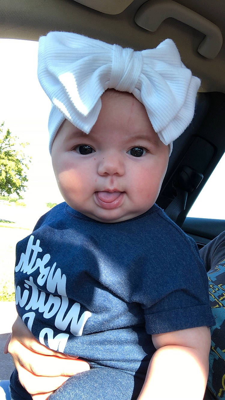 Heidi is registered to the contest to win money with this photo: baby, baby_toddler_clothing, blue, cap, child, costume_hat, electric_blue, eye, happy, hat, headgear, headwear, human_body, person, plant, skin, sleeve, smile, sun_hat, t_shirt