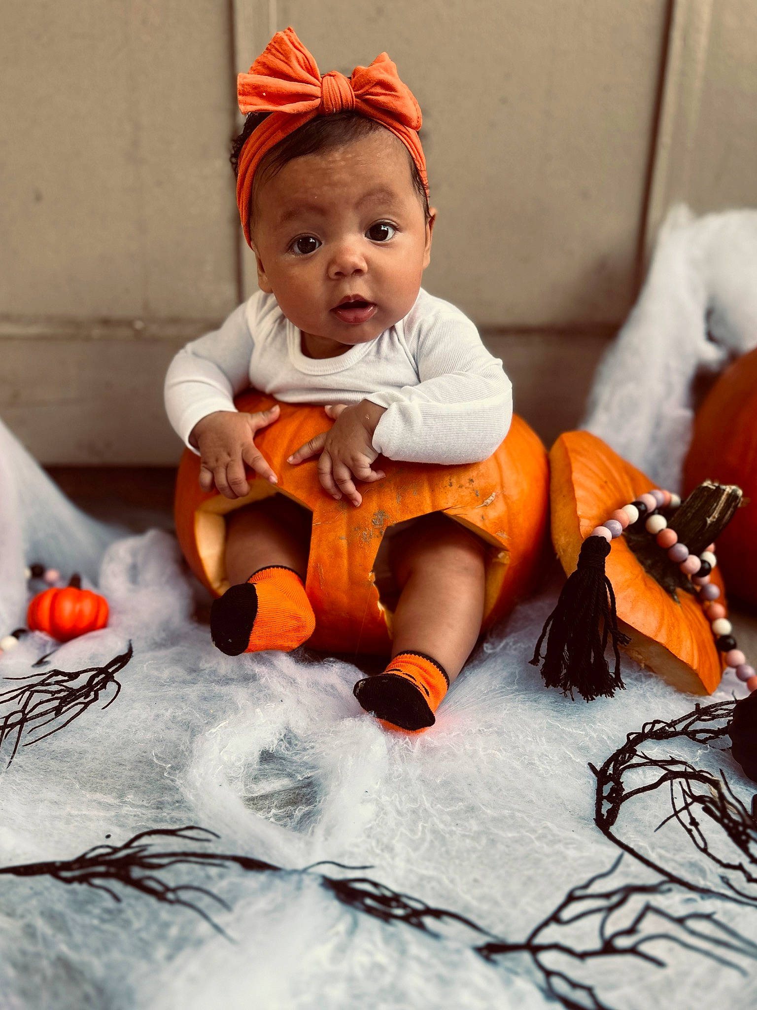 Armani joined the competition — help win amazing prizes! baby, baby_toddler_clothing, calabaza, cap, child, comfort, doll, face, fashion_accessory, headgear, human_body, orange, person, pumpkin, sitting, stuffed_toy, textile, toddler, toy, winter_squash
