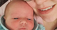 Wyatt is registered to the contest to win money with this photo: baby, adult, glasses, smile, face, portrait, indoor, couch, clothing, person, hand, closeup, skin, eyewear, happy, newborn, casual, family, together, love
