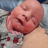 Wyatt joined the competition — help win amazing prizes! newborn, baby, sleeping, closeup, face, skin, clothing, pattern, red, gray, person, tattoo, hand, resting, peaceful, infant, portrait, indoors, soft, cute