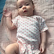 Jupiter joined the competition — help win amazing prizes! baby, infant, blanket, onesie, pink, pattern, hand, face, skin, lying_down, cute, soft, fabric, child, newborn, clothing, portrait, person, indoor, resting