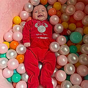 Mya participe au concours pour gagner de l'argent avec cette photo : baby, infant, child, red_clothing, minnie_mouse, ball_pit, colorful_balls, pink, orange, teal, yellow, smiling, happy, cute, indoors, soft_texture, playtime, portrait, person, footed_pajamas
