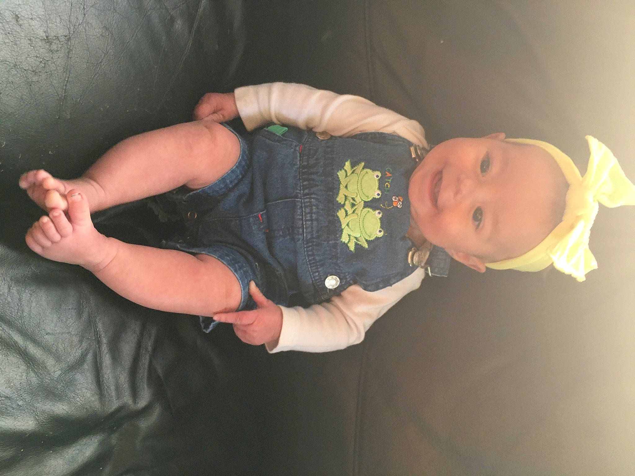 Faye is registered to the contest to win money with this photo: abdomen, arm, baby, baby_toddler_clothing, comfort, elbow, eye, finger, gesture, hand, headgear, human_body, joy, lap, leg, mouth, person, sleeve, thigh, toddler