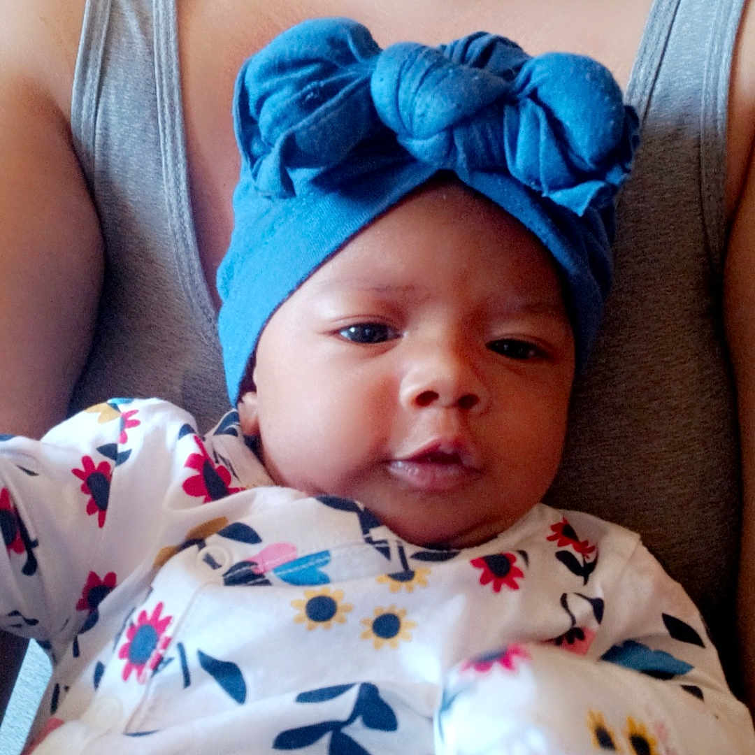 Sha'Niya is registered to the contest to win money with this photo: accessories, architecture, baby, bonnet, building, cap, clothing, cushion, dress, face, glove, hat, head, homedecor, hospital, newborn, person, photography, portrait, sleeping