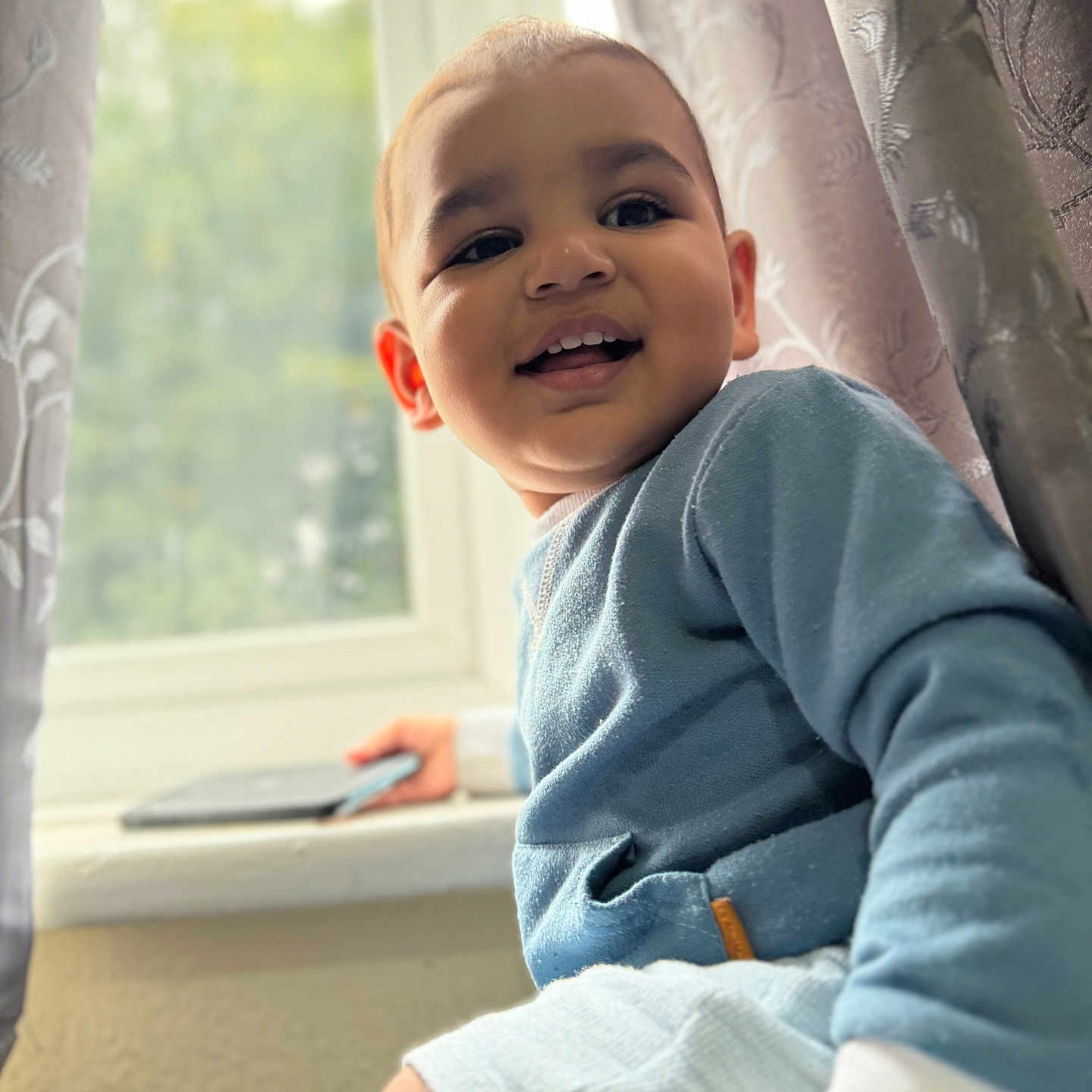 Eric joined the competition — help win amazing prizes! baby, babylaughing, bodypart, clothing, curtain, face, finger, hand, happy, head, laughing, longsleeve, person, photography, portrait, sitting, sleeve, smile, window, windowsill