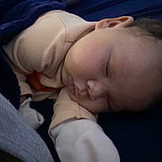 Layla is registered to the contest to win money with this photo: baby, blanket, child, closeup, clothing, cozy, cute, face, head, indoors, infant, nap, newborn, peaceful, portrait, resting, skin, sleeping, soft, warm