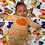 baby, infant, child, blanket, butterfly, colorful, clothing, pumpkin, cute, wooden_sign, 2_months, laying_down, portrait, face, smile, soft, pattern, fabric, sleepwear, newborn