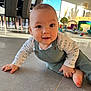 baby, infant, child, smile, face, eyes, crawling, playroom, toys, tiles, floor, overalls, onesie, hand, foot, indoors, natural_light, chair, window, furniture