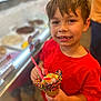 Maverix Ryder is registered to the contest to win money with this photo: child, boy, ice_cream, cone, sprinkles, gummy_worms, red_shirt, smiling, food, dessert, indoor, counter, happy, sweet, treat, person, candy, hand, face, blurred_background