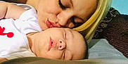 Maverix Ryder joined the competition — help win amazing prizes! baby, woman, sleeping, kiss, love, tender, closeup, face, skin, blonde, person, bed, rest, affection, family, care, comfort, peaceful, indoor, portrait