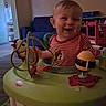 baby, child, infant, smiling, laughing, portrait, indoor, living_room, activity_center, toy, playtime, striped_shirt, red_shirt, seated, happy, face, furniture, colorful, home, photography