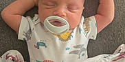 Jensen is registered to the contest to win money with this photo: baby, sleeping, pacifier, blanket, infant, cute, peaceful, child, soft, comfort, clothing, rest, newborn, lying_down, hands_up, indoors, portrait, cozy, nap, adorable