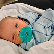 Jensen is registered to the contest to win money with this photo: baby, newborn, pacifier, blanket, blue_striped_clothing, infant, face, cute, sleeping, hand, wrapped, soft, skin, child, portrait, lying_down, indoors, newborn_baby, cozy, peaceful