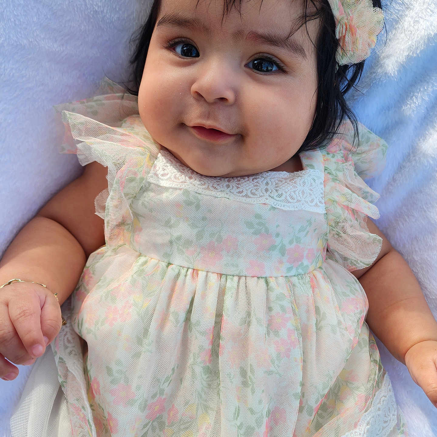 Rubi joined the competition — help win amazing prizes! adorable, baby, child, chubby_cheeks, closeup, cute, dress, eyes, face, floral_pattern, flower_headband, hand, happy, infant, person, portrait, skin, smile, soft_blanket, young_child