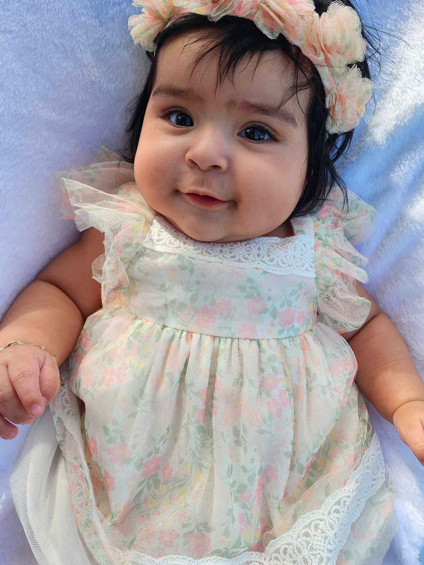 Rubi joined the competition — help win amazing prizes! baby, infant, child, face, smile, flower_headband, dress, floral_pattern, cute, soft_blanket, chubby_cheeks, portrait, closeup, happy, adorable, young_child, skin, hand, eyes, person