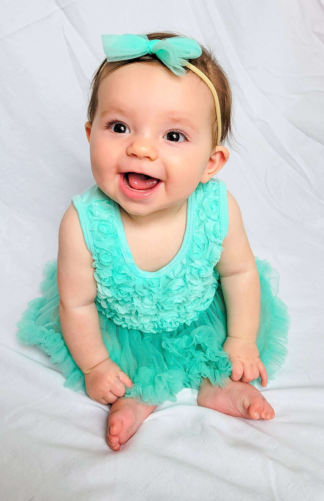 Hadley is registered to the contest to win money with this photo: aqua, azure, baby, baby_toddler_clothing, cheek, dress, eye, face, flash_photography, happy, head, headwear, iris, person, pink, product, purple, skin, sleeve, smile