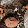 dog, person, sleeping, cuddle, indoor, bed, blanket, casual_clothing, relaxed, close_up, face, pet, resting, comfort, human, animal, cozy, laying_down, companionship, affection