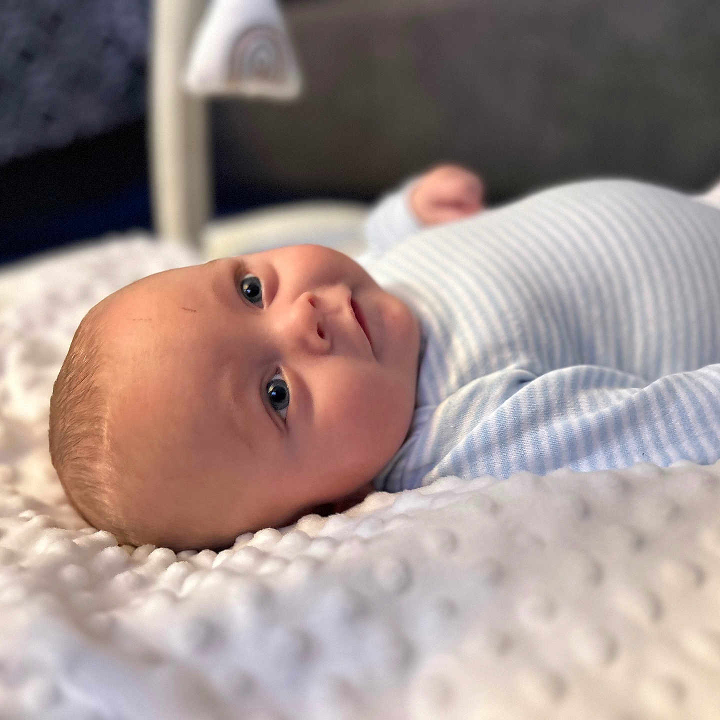 Braxton is registered to the contest to win money with this photo: baby, babylaughing, bed, blanket, crib, face, furniture, happy, head, infantbed, newborn, person, photography, portrait, smile