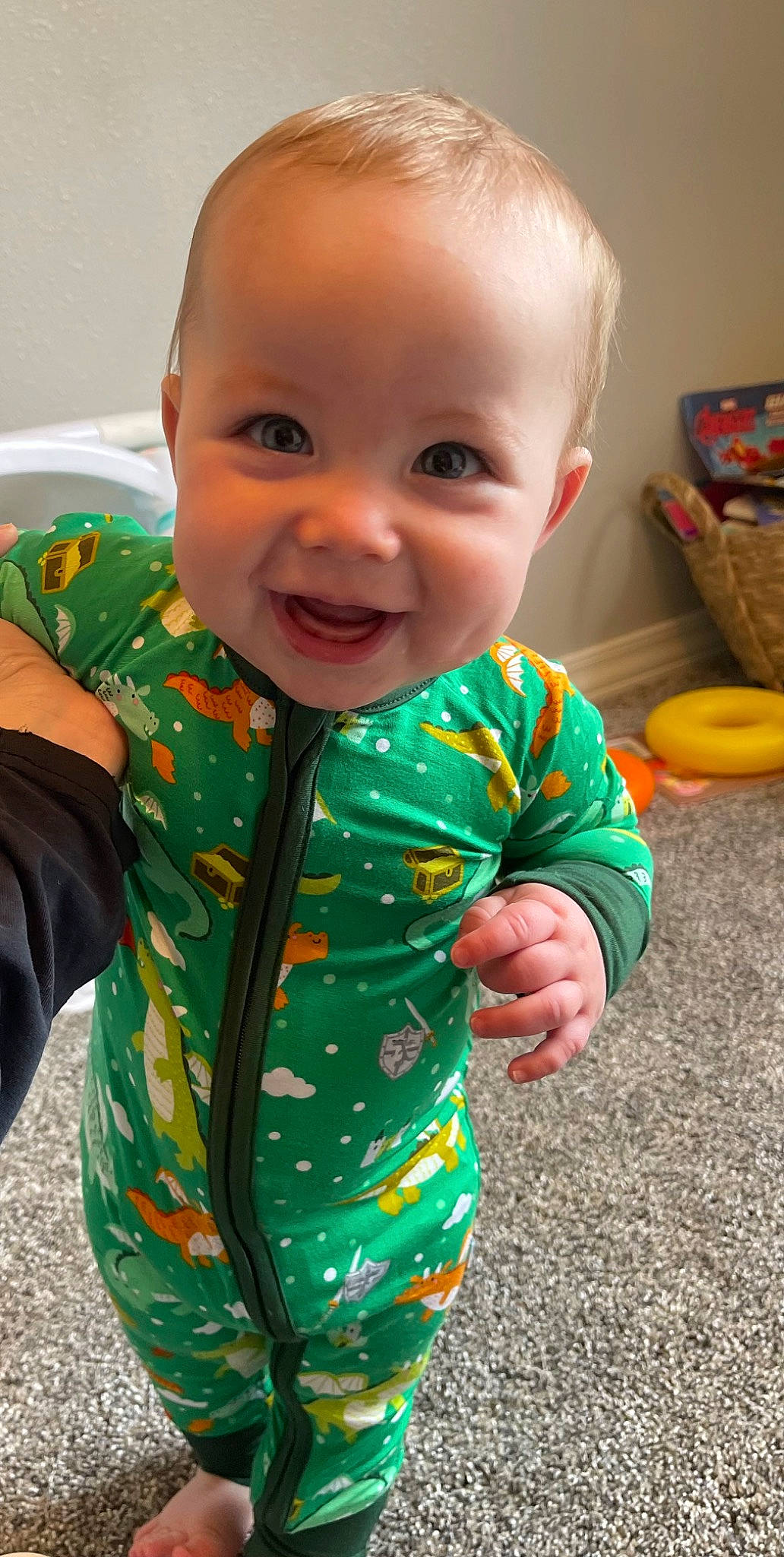 Sterling is registered to the contest to win money with this photo: arm, baby, baby_toddler_clothing, cheek, facial_expression, finger, fun, happy, iris, neck, nose, orange, outerwear, person, product, skin, sleeve, smile, standing, t_shirt