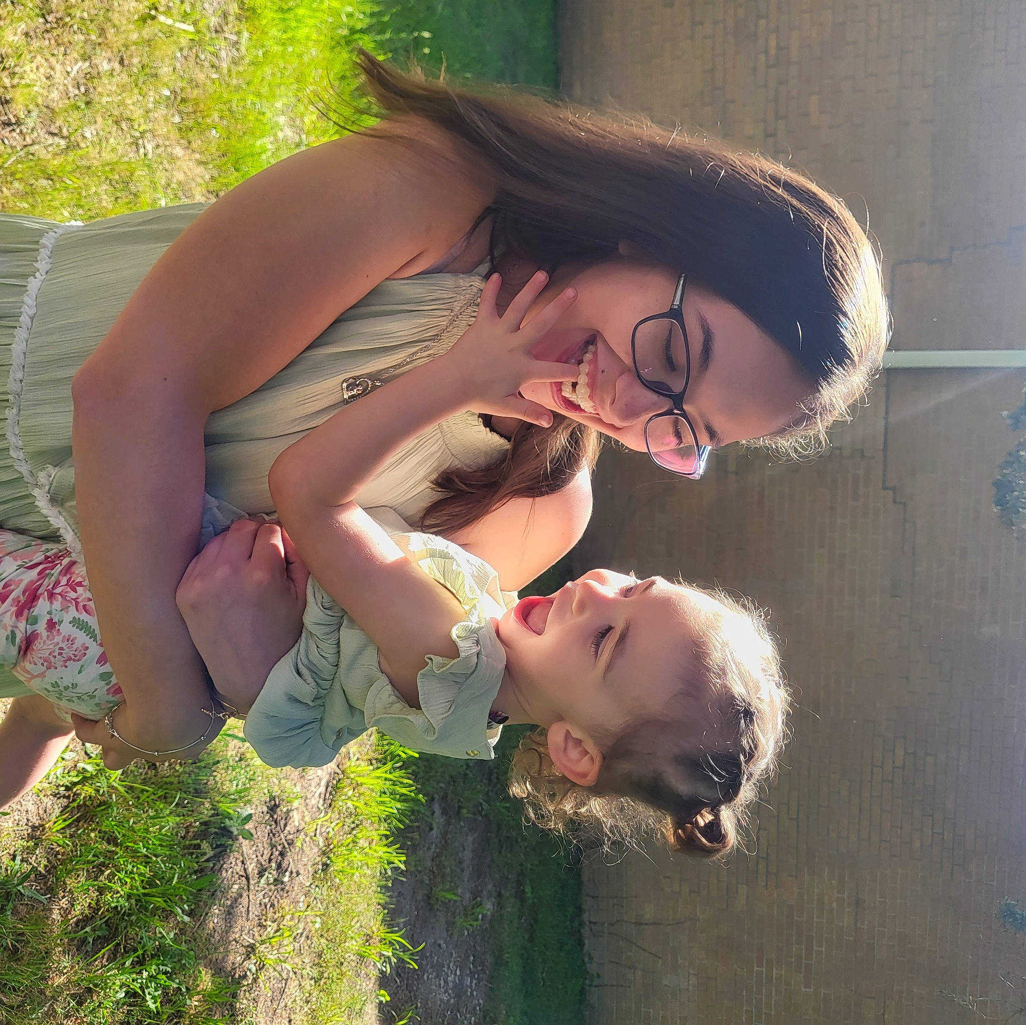 Aubree is registered to the contest to win money with this photo: brown_hair, child, eyewear, flash_photography, fun, gesture, grass, grassland, happy, human_leg, joy, leisure, long_hair, people_in_nature, person, plant, skin, smile, summer, thigh