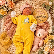 Evelyn joined the competition — help win amazing prizes! newborn, baby, sleeping, portrait, yellow_outfit, onesie, bonnet, mittens, teddy_bear, flowers, roses, dried_flowers, floral_arrangement, knitted_blanket, basket, wooden_sign, birth_announcement, nursery, cozy, infant