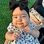 Zhoe is registered to the contest to win money with this photo: baby, infant, child, headband, bow, clothing, dress, hand, face, outdoor, grass, person, cute, smile, sunlight, skin, holding, portrait, happy, young