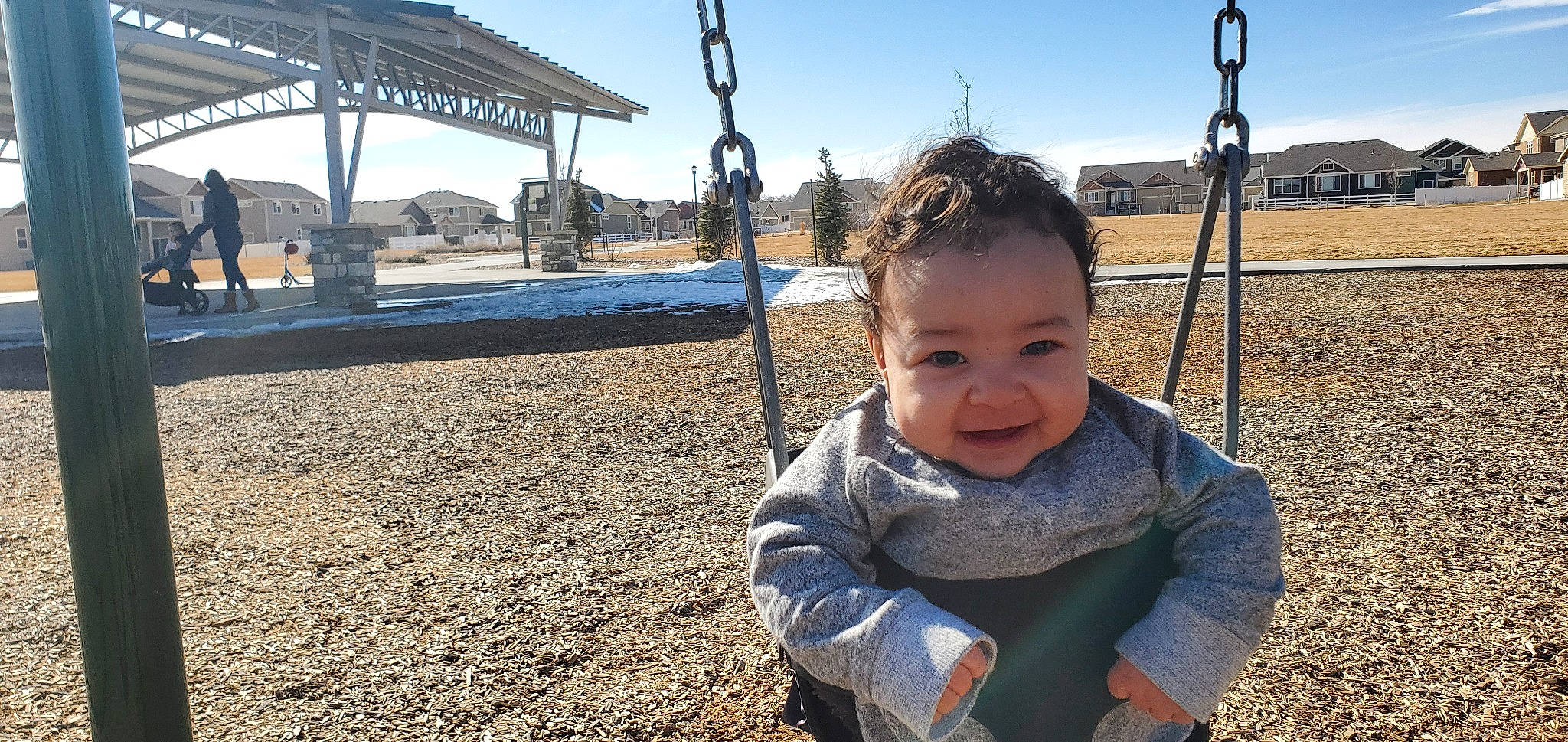 Edison is registered to the contest to win money with this photo: child, city, fun, joy, leisure, outdoor_play_equipment, person, plant, play, playground, public_space, recreation, smile, swing, toddler, tree, vacation