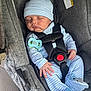 baby, sleeping, car_seat, pacifier, striped_clothing, blue_hat, infant, child, seatbelt, safety, cute, newborn, hand, footwear, plush_toys, gray, fabric, indoor, person, resting