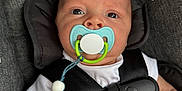 Oaklan joined the competition — help win amazing prizes! baby, pacifier, car_seat, harness, white_shirt, beaded_pacifier_clip, close_up, infant, child, seatbelt, gray_fabric, safety_label, clip, straps, child_safety, cute, portrait, indoors, person, baby_accessory