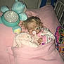 toddler, sleeping, blanket, stuffed_animal, toy, bed, pacifier, cozy, child, plush, indoor, pink, blue, nighttime, quiet, rest, comfort, pajamas, hospital_bed, medical_tape