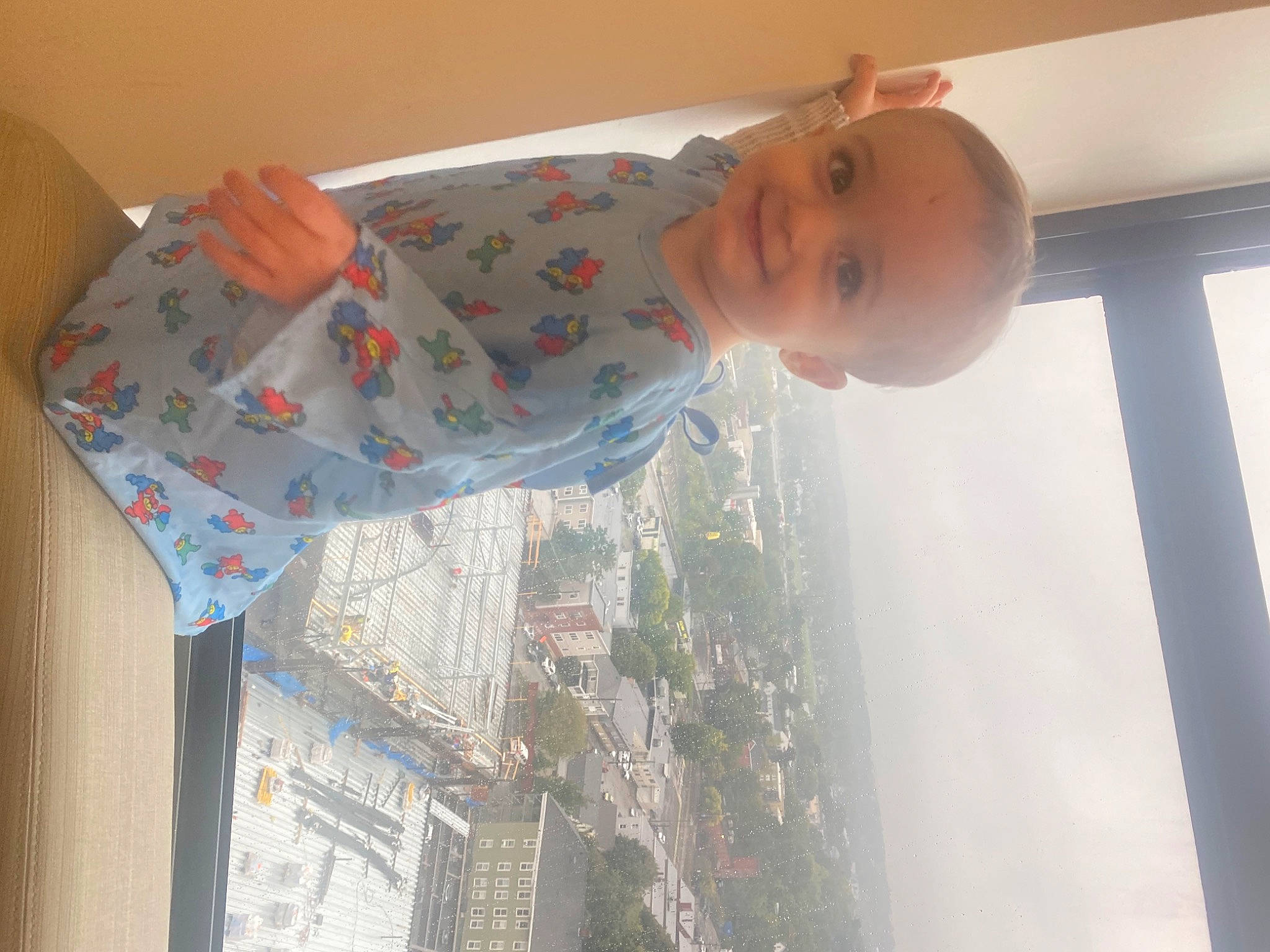 Nikolas is registered to the contest to win money with this photo: baby, baby_products, baby_toddler_clothing, child, dress, flooring, fun, joy, linens, pajamas, pattern, person, product, room, sleeve, textile, toddler