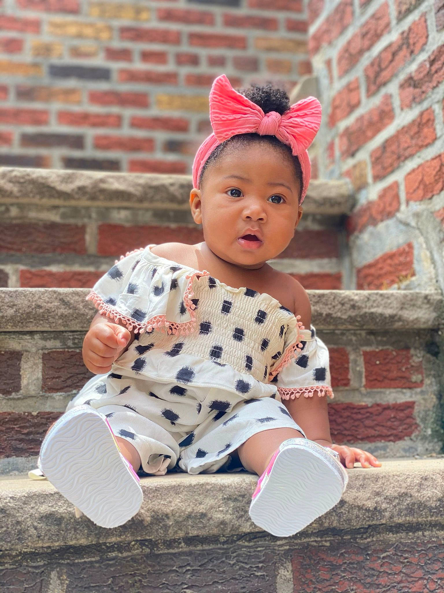 Milan joined the competition — help win amazing prizes! baby, baby_toddler_clothing, brick, brickwork, cap, child, costume_hat, flooring, happy, headgear, lip, magenta, orange, pattern, person, pink, sleeve, street_fashion, surprise, textile