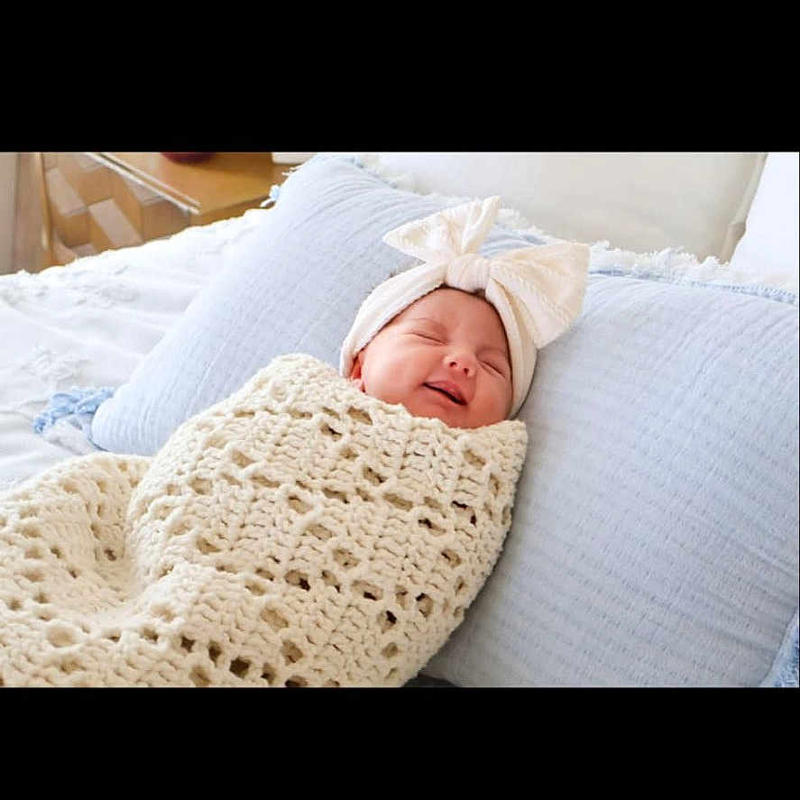 Amelia is registered to the contest to win money with this photo: architecture, baby, bed, blanket, building, clothing, cushion, electronics, face, furniture, hat, head, homedecor, hospital, newborn, person, photography, portrait, sleeping, text