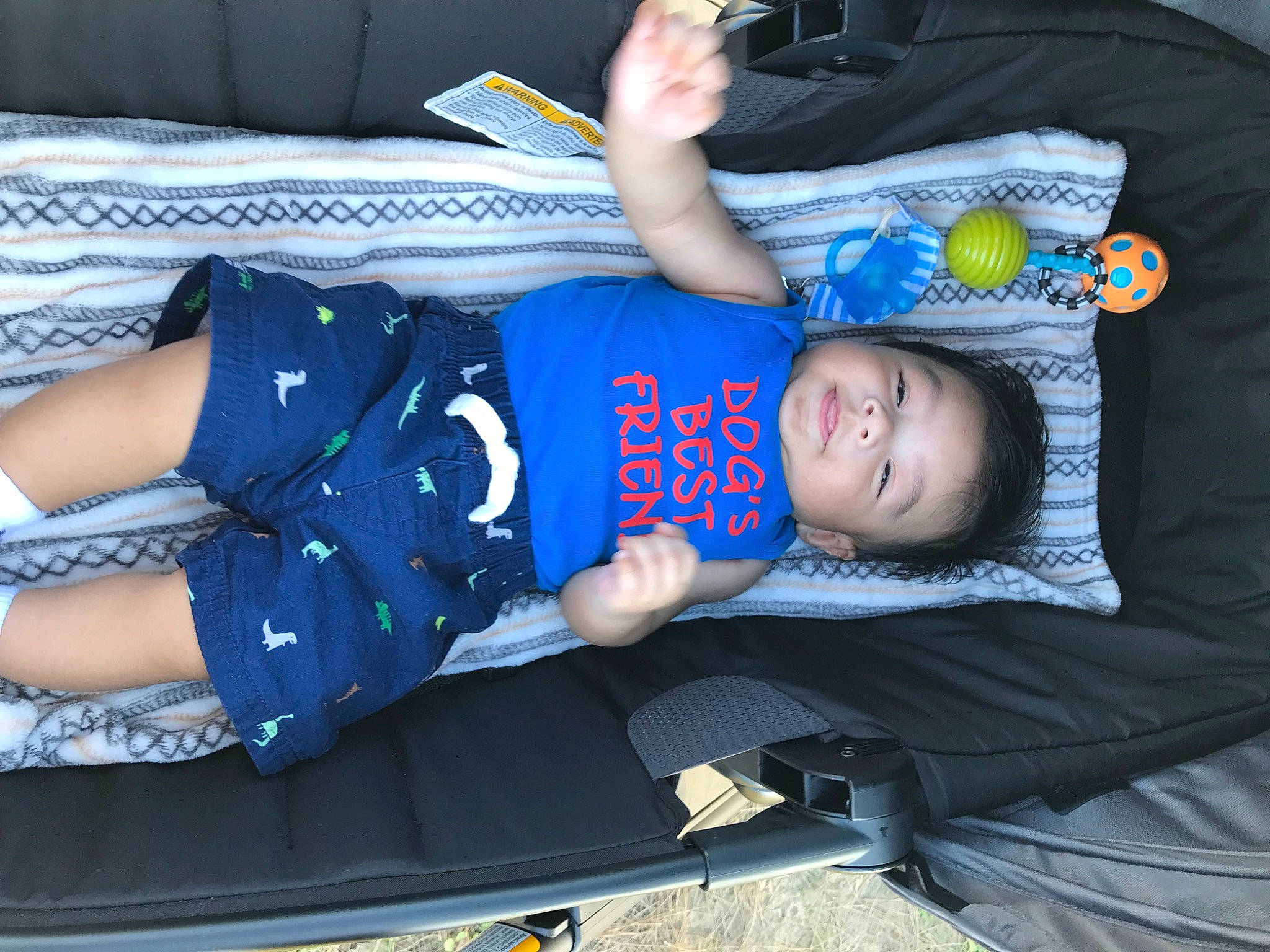 Jace Kai is registered to the contest to win money with this photo: arm, baby, baby_products, baby_toddler_clothing, child, comfort, elbow, electric_blue, fun, hat, lap, pattern, person, sitting, t_shirt, toddler, vacation