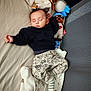Adam participe au concours pour gagner de l'argent avec cette photo : baby, sleeping, blanket, stuffed_toys, soft_toys, crib, child, infant, pajamas, cozy, nursery, cute, peaceful, resting, toddler, fabric, mesh, striped_socks, plush, comfort