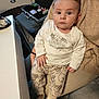 Adam participe au concours pour gagner de l'argent avec cette photo : baby, child, indoor, clothing, winnie_the_pooh, pajamas, person, face, seat, chair, hand, footwear, socks, table, poker_chips, playing_cards, curious, portrait, cute, expression
