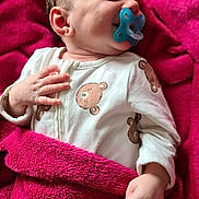 Adam participe au concours pour gagner de l'argent avec cette photo : baby, pacifier, blanket, onesie, bear_print, sleeping, infant, child, soft_texture, pink, white_clothing, hand, face, cute, cozy, closeup, indoors, young_child, peaceful, portrait