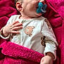 baby, pacifier, blanket, onesie, bear_print, sleeping, infant, child, soft_texture, pink, white_clothing, hand, face, cute, cozy, closeup, indoors, young_child, peaceful, portrait