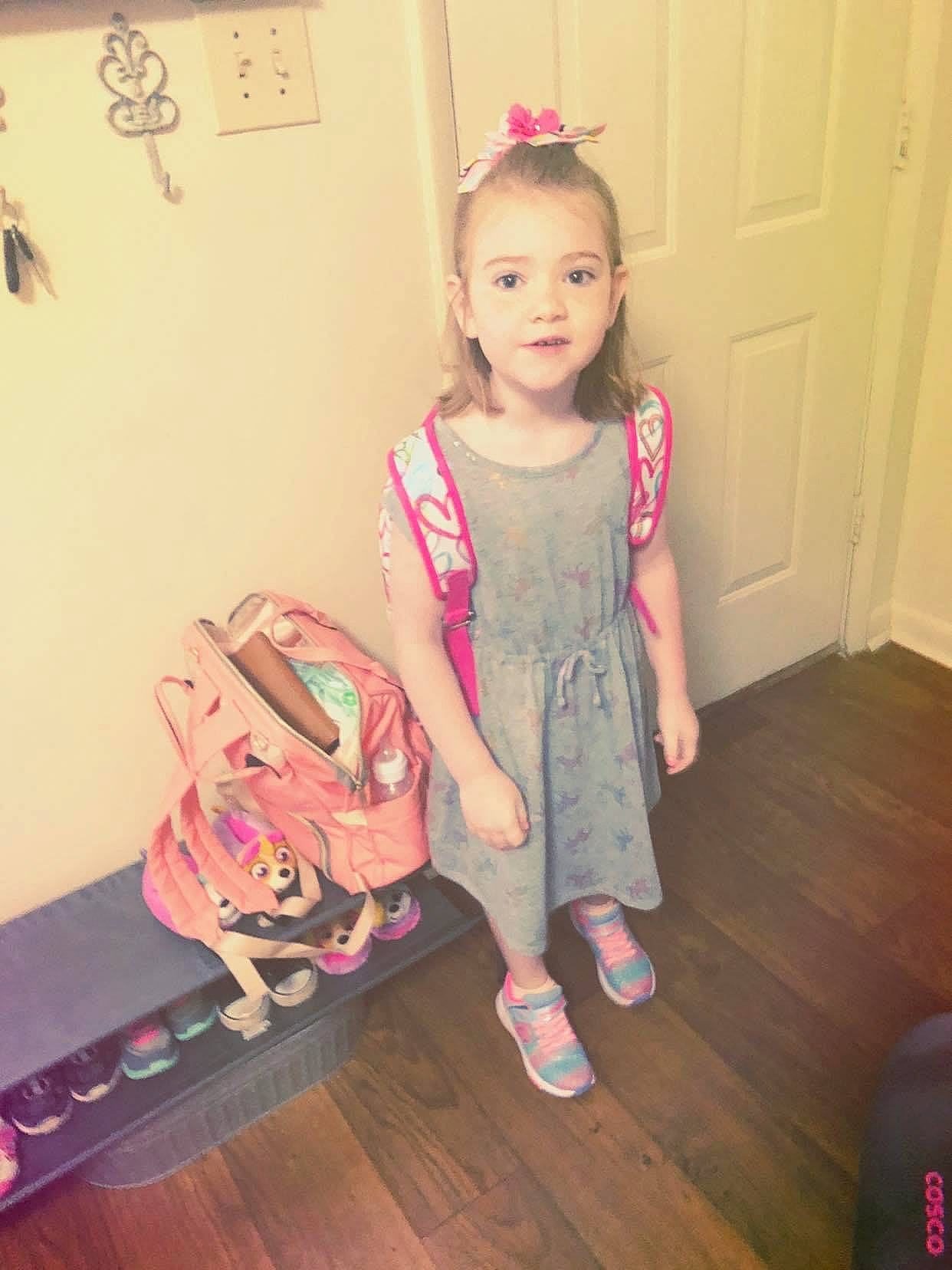 Kyndal is registered to the contest to win money with this photo: baby_toddler_clothing, bag, child, computer_keyboard, door, dress, fashion_accessory, fashion_design, flooring, fun, happy, laptop, magenta, pattern, person, pink, sitting, sleeve, sock, toddler