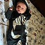 baby, infant, hoodie, nike, black_clothing, lying_down, blanket, animal_print, lion, giraffe, elephant, zebra, cute, face, expression, footwear, socks, indoor, child, young