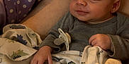 Quentin is registered to the contest to win money with this photo: baby, blanket, pacifier, polka_dot, purple, sleeping, infant, clothing, pattern, dinosaur, bed, bedding, hand, face, person, cozy, resting, cute, soft, indoors