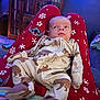 Quentin joined the competition — help win amazing prizes! baby, infant, pajamas, bear_print, red_pants, snowflakes, stitch_character, face, person, legs, couch, living_room, wooden_cabinet, blanket, footwear, comfort, indoor, child, cute, relaxing