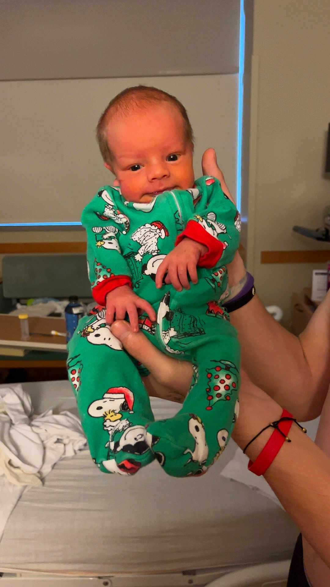 Quentin joined the competition — help win amazing prizes! baby, infant, child, pajamas, snoopy, green_clothing, hand, adult, bed, blanket, indoor, person, sleepwear, cute, newborn, holding, portrait, home, room, soft_lighting