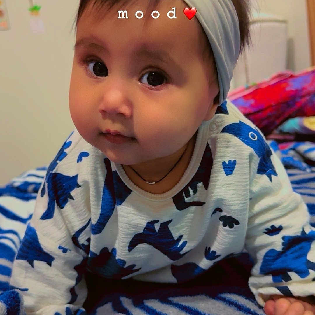 Sumati is registered to the contest to win money with this photo: accessories, baby, bed, bedroom, blanket, clothing, crawling, face, furniture, head, headband, indoors, jewelry, necklace, person, photography, portrait, quilt, room, toy